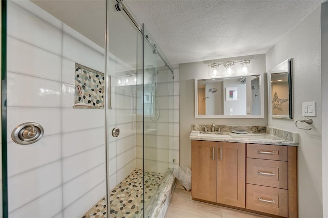17408 Gulf Blvd Unit 601, Redington Shores, FL 33708 - bathroom with a stall shower, a textured ceiling, and vanity