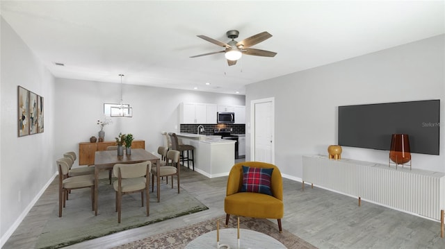 3051 27th Ct E, Palmetto, FL 34221 - dining space with light wood-type flooring, a ceiling fan, a chandelier, and recessed lighting