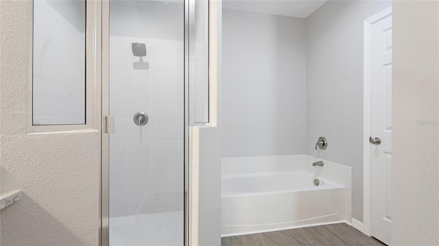 3051 27th Ct E, Palmetto, FL 34221 - bathroom featuring a stall shower, a garden tub, and wood finished floors