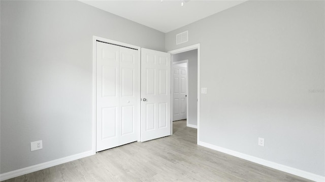 3051 27th Ct E, Palmetto, FL 34221 - unfurnished bedroom featuring light wood-style flooring and a closet