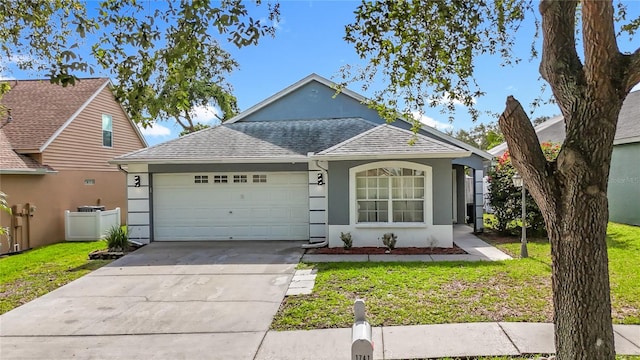 1741 Oak Spring Dr, Tarpon Springs, FL 34689 - view of front of home featuring an attached garage, stucco siding, roof with shingles, and driveway