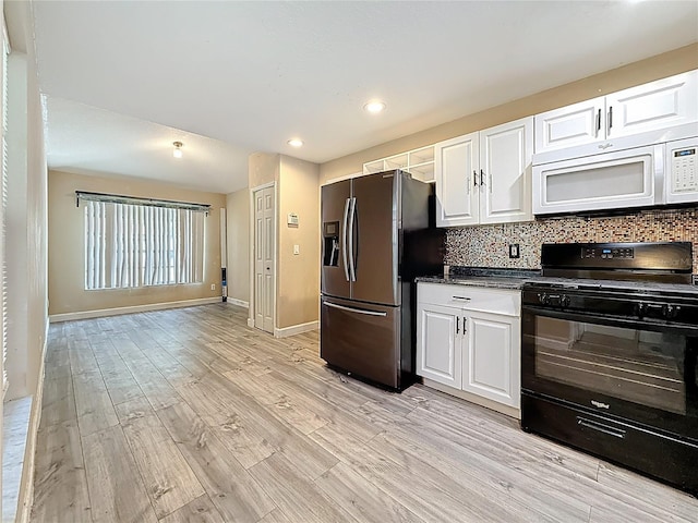 1741 Oak Spring Dr, Tarpon Springs, FL 34689 - kitchen featuring fridge with ice dispenser, black range with electric cooktop, white microwave, white cabinets, and recessed lighting