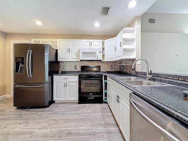 1741 Oak Spring Dr, Tarpon Springs, FL 34689 - kitchen with appliances with stainless steel finishes, open shelves, dark countertops, white cabinets, and recessed lighting