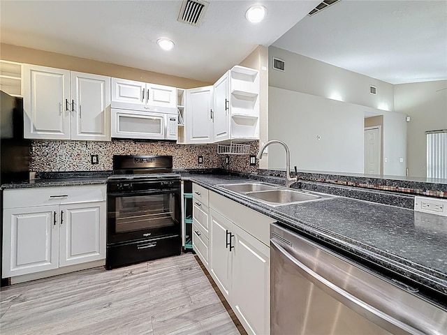 1741 Oak Spring Dr, Tarpon Springs, FL 34689 - kitchen featuring white microwave, black gas range oven, open shelves, dishwasher, and white cabinets