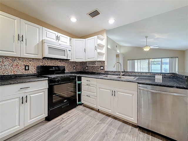 1741 Oak Spring Dr, Tarpon Springs, FL 34689 - kitchen with dishwasher, white microwave, black range oven, white cabinetry, and lofted ceiling
