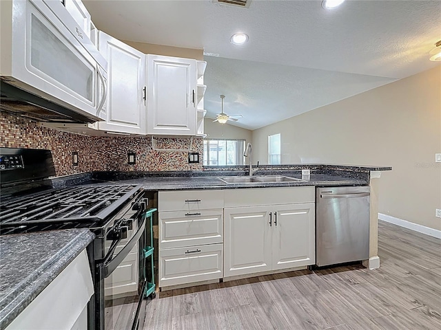 1741 Oak Spring Dr, Tarpon Springs, FL 34689 - kitchen featuring black gas range oven, white microwave, stainless steel dishwasher, lofted ceiling, and a ceiling fan
