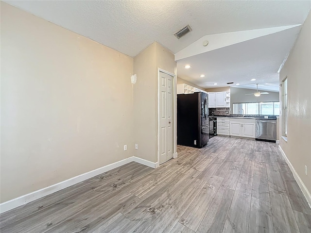 1741 Oak Spring Dr, Tarpon Springs, FL 34689 - unfurnished living room with light wood-style floors, lofted ceiling, recessed lighting, and ceiling fan