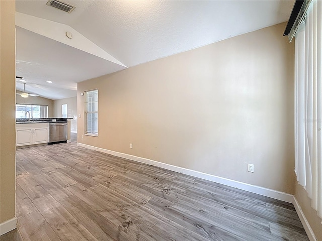 1741 Oak Spring Dr, Tarpon Springs, FL 34689 - unfurnished living room featuring lofted ceiling, light wood-type flooring, and ceiling fan
