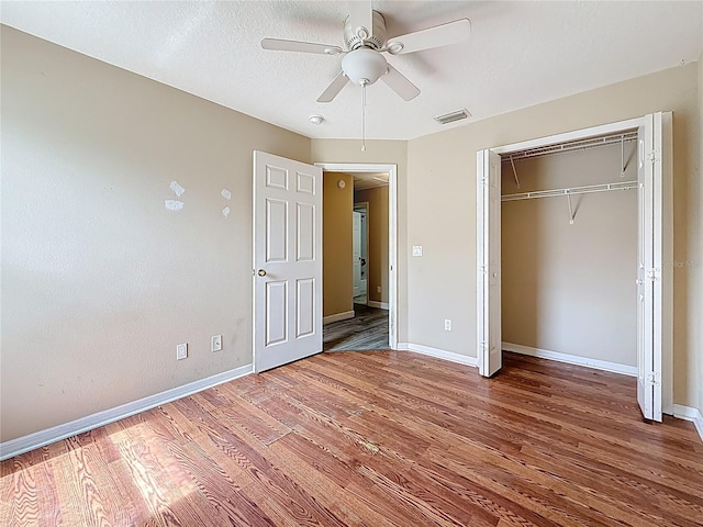 1741 Oak Spring Dr, Tarpon Springs, FL 34689 - unfurnished bedroom featuring wood finished floors, a closet, and ceiling fan