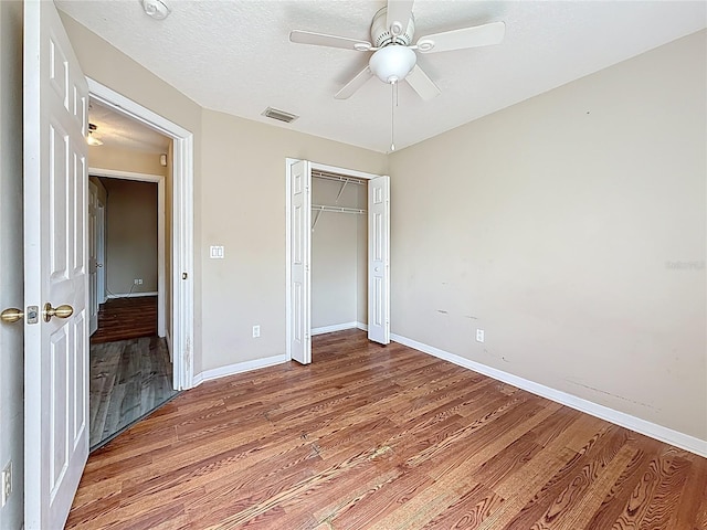 1741 Oak Spring Dr, Tarpon Springs, FL 34689 - unfurnished bedroom featuring wood finished floors, a closet, and a ceiling fan