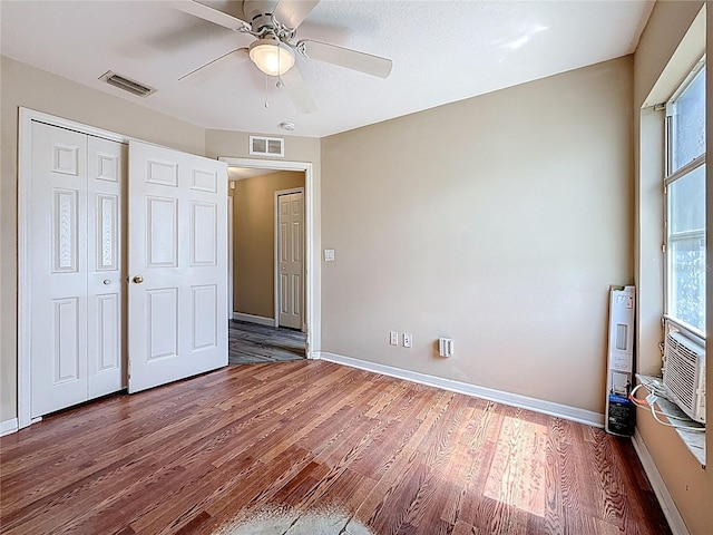 1741 Oak Spring Dr, Tarpon Springs, FL 34689 - unfurnished bedroom featuring wood finished floors, ceiling fan, and a closet