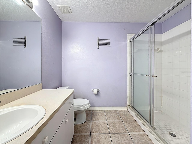 1741 Oak Spring Dr, Tarpon Springs, FL 34689 - bathroom featuring a stall shower, vanity, a textured ceiling, and tile patterned floors