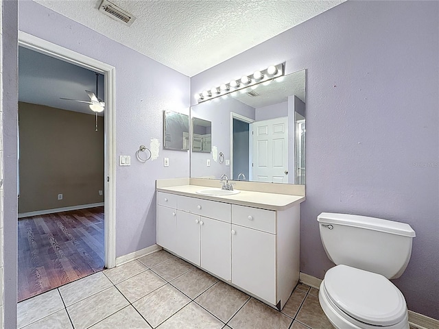 1741 Oak Spring Dr, Tarpon Springs, FL 34689 - bathroom featuring vanity, ceiling fan, tile patterned flooring, and a textured ceiling
