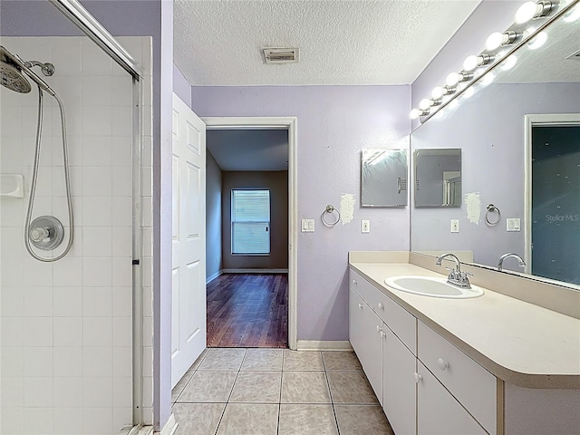 1741 Oak Spring Dr, Tarpon Springs, FL 34689 - full bath with a shower stall, vanity, tile patterned flooring, and a textured ceiling