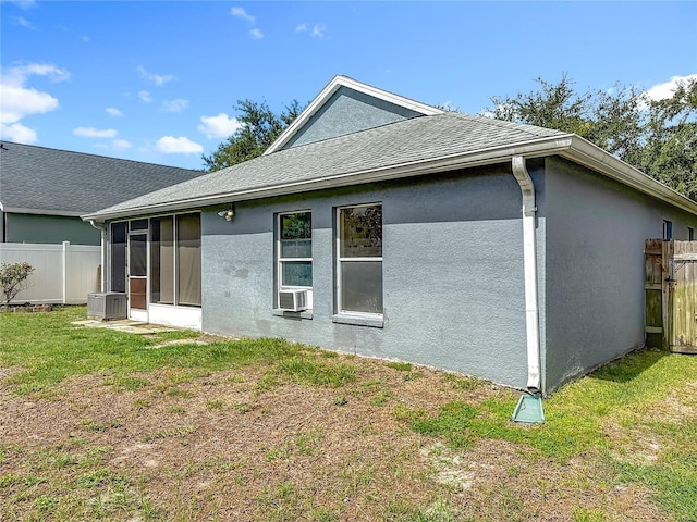 1741 Oak Spring Dr, Tarpon Springs, FL 34689 - back of property featuring stucco siding, a sunroom, and a shingled roof