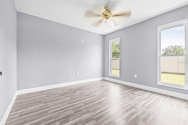 10430 Bobcat Dr, New Port Richey, FL 34654 - empty room featuring wood finished floors and ceiling fan