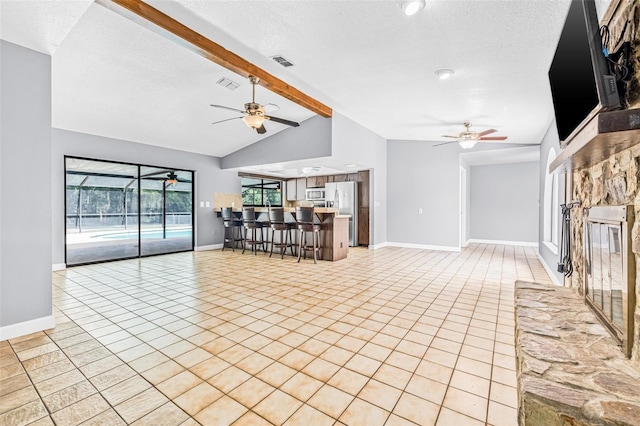 10430 Bobcat Dr, New Port Richey, FL 34654 - unfurnished living room with a ceiling fan, light tile patterned floors, and a textured ceiling