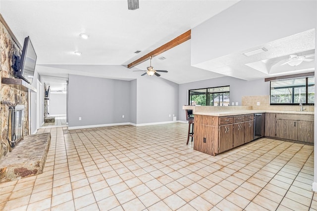 10430 Bobcat Dr, New Port Richey, FL 34654 - kitchen with ceiling fan, light countertops, a peninsula, dishwashing machine, and open floor plan