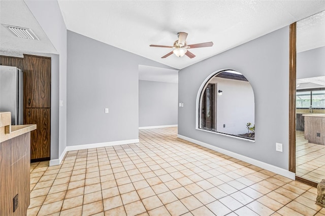 10430 Bobcat Dr, New Port Richey, FL 34654 - empty room with a ceiling fan, lofted ceiling, and light tile patterned floors