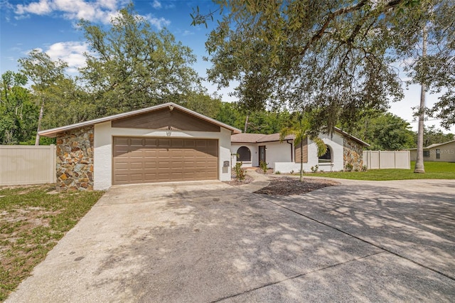 10430 Bobcat Dr, New Port Richey, FL 34654 - view of front of home featuring driveway, a garage, and stucco siding