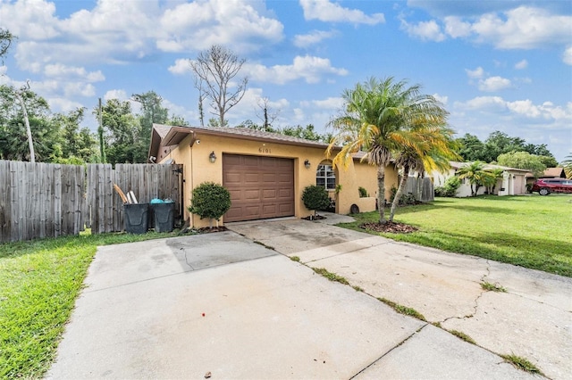 6101 Broken Arrow Dr, New Port Richey, FL 34653 - view of front of home with stucco siding, concrete driveway, and a garage