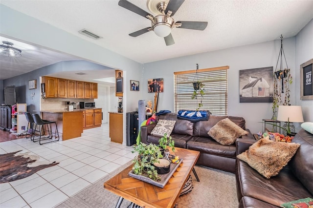 6101 Broken Arrow Dr, New Port Richey, FL 34653 - living area with a ceiling fan, light tile patterned flooring, and a textured ceiling
