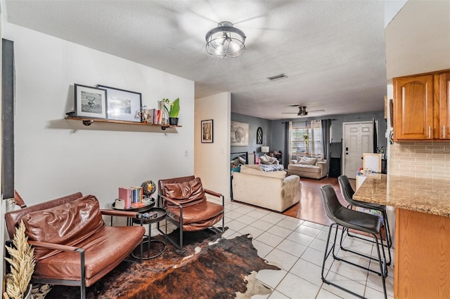 6101 Broken Arrow Dr, New Port Richey, FL 34653 - dining area with light tile patterned flooring, a textured ceiling, and a ceiling fan