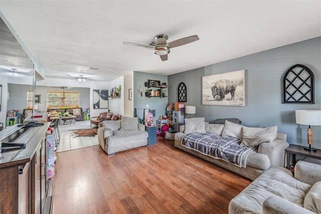 6101 Broken Arrow Dr, New Port Richey, FL 34653 - living area with a ceiling fan and light wood-type flooring