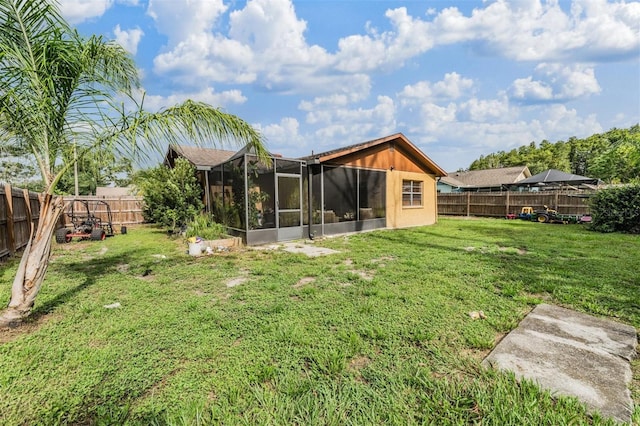 6101 Broken Arrow Dr, New Port Richey, FL 34653 - rear view of house with a fenced backyard and a sunroom
