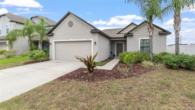 14317 Italia Dr, Wimauma, FL 33598 - view of front facade with stucco siding, an attached garage, and driveway