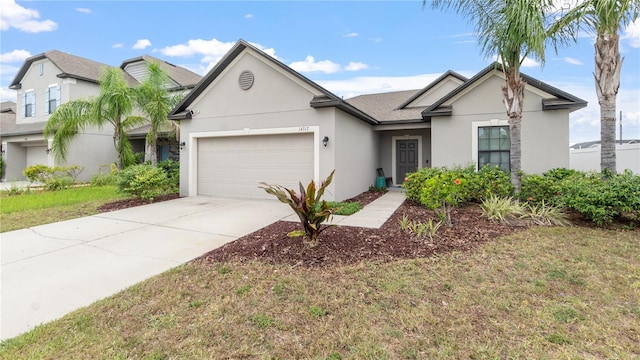 14317 Italia Dr, Wimauma, FL 33598 - view of front of house with stucco siding, a garage, and driveway
