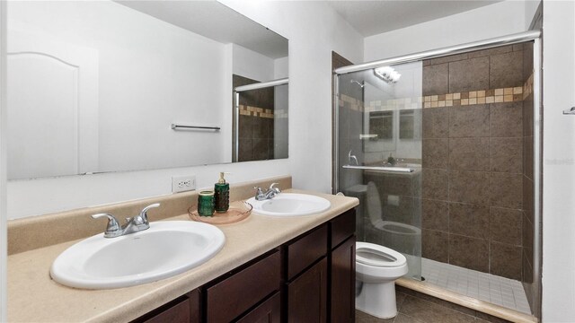 14317 Italia Dr, Wimauma, FL 33598 - full bathroom with a stall shower, double vanity, and tile patterned floors