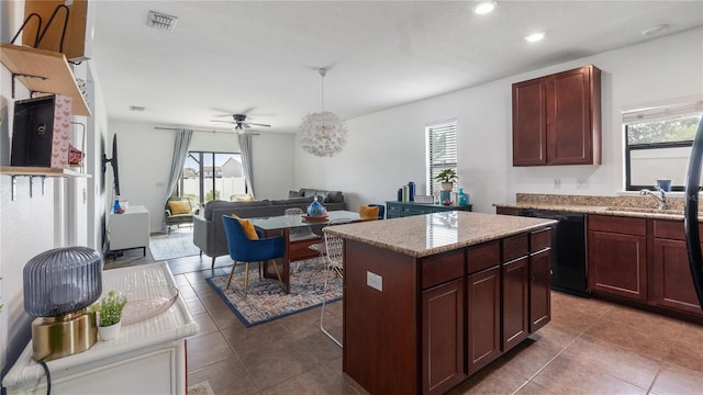 14317 Italia Dr, Wimauma, FL 33598 - kitchen featuring black dishwasher, plenty of natural light, a kitchen island, ceiling fan, and recessed lighting