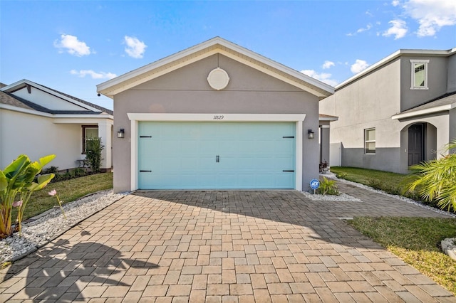 11829 Brighton Knoll Loop, Riverview, FL 33579 - view of front facade featuring decorative driveway, stucco siding, and a garage
