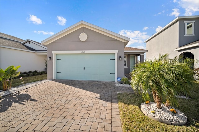 11829 Brighton Knoll Loop, Riverview, FL 33579 - single story home featuring decorative driveway, stucco siding, and a garage