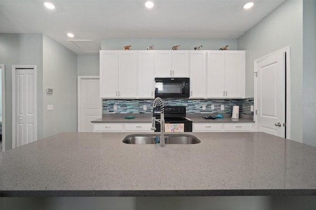 11829 Brighton Knoll Loop, Riverview, FL 33579 - kitchen featuring black appliances, tasteful backsplash, recessed lighting, white cabinetry, and a kitchen island with sink