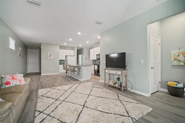11829 Brighton Knoll Loop, Riverview, FL 33579 - living room featuring light wood-style flooring and recessed lighting