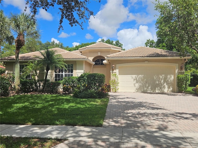 6900 Molakai Cir, Boynton Beach, FL 33437 - mediterranean / spanish home with a tile roof, a garage, decorative driveway, and a front yard
