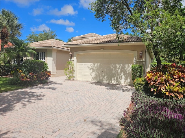 6900 Molakai Cir, Boynton Beach, FL 33437 - mediterranean / spanish-style house featuring stucco siding, a garage, a tiled roof, and decorative driveway