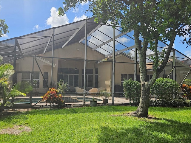 6900 Molakai Cir, Boynton Beach, FL 33437 - back of house featuring stucco siding, a lanai, a lawn, and an outdoor pool