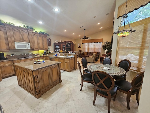 6900 Molakai Cir, Boynton Beach, FL 33437 - kitchen featuring white microwave, a peninsula, recessed lighting, lofted ceiling, and open floor plan