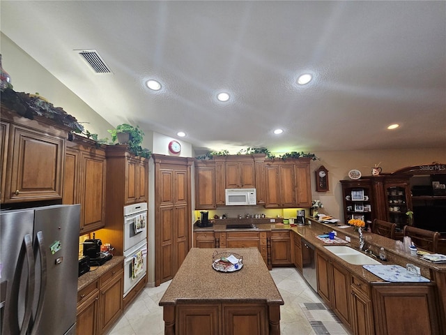 6900 Molakai Cir, Boynton Beach, FL 33437 - kitchen featuring stainless steel appliances, a peninsula, a center island, recessed lighting, and brown cabinetry