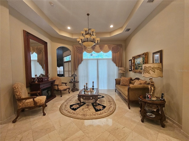6900 Molakai Cir, Boynton Beach, FL 33437 - living area featuring a chandelier, arched walkways, a raised ceiling, recessed lighting, and light marble finish floors