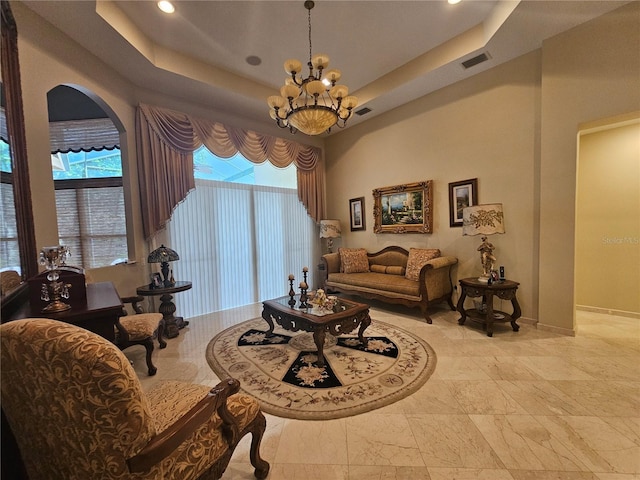 6900 Molakai Cir, Boynton Beach, FL 33437 - living room featuring arched walkways, a chandelier, a raised ceiling, healthy amount of natural light, and recessed lighting