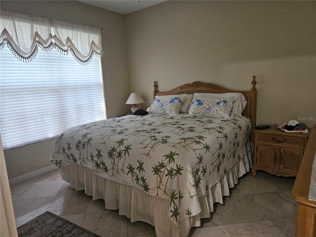 6900 Molakai Cir, Boynton Beach, FL 33437 - bedroom featuring light marble finish floors and baseboards