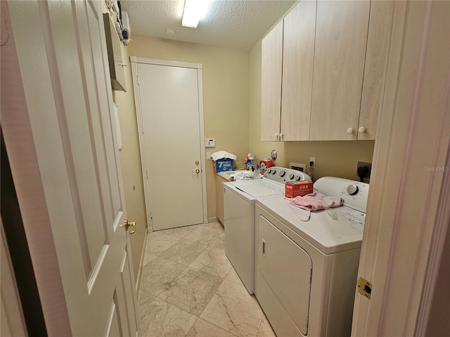 6900 Molakai Cir, Boynton Beach, FL 33437 - laundry room featuring cabinet space, washing machine and clothes dryer, light marble finish flooring, and a textured ceiling