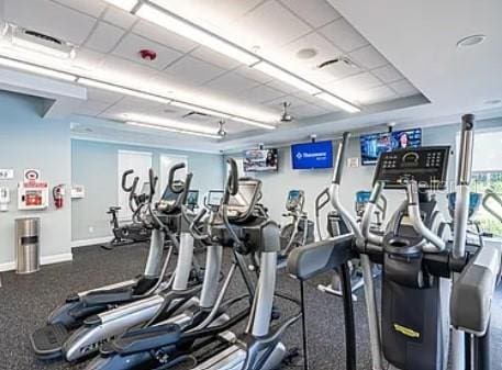 6900 Molakai Cir, Boynton Beach, FL 33437 - exercise room featuring a paneled ceiling and baseboards