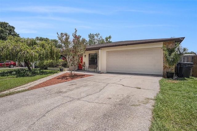 750 Caliente Dr, Brandon, FL 33511 - ranch-style home featuring driveway, an attached garage, stucco siding, and a front yard