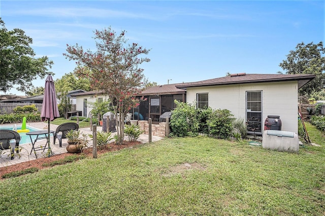 750 Caliente Dr, Brandon, FL 33511 - rear view of house with a patio, a sunroom, and a shingled roof