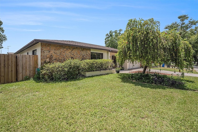 750 Caliente Dr, Brandon, FL 33511 - view of side of home featuring stone siding and a garage
